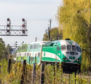 Toronto Metrolinx GO transit MotivePower Industries Corporation locomotive 634 pushing a commuter train into the suburban Streetsville station.