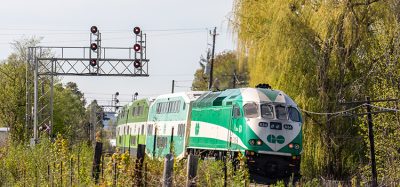 Toronto Metrolinx GO transit MotivePower Industries Corporation locomotive 634 pushing a commuter train into the suburban Streetsville station.