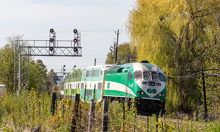 Toronto Metrolinx GO transit MotivePower Industries Corporation locomotive 634 pushing a commuter train into the suburban Streetsville station.