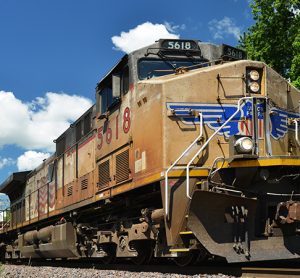 Union Pacific diesel locomotive pulling a freight train of container cars