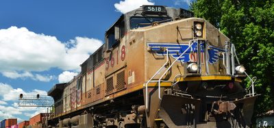 Union Pacific diesel locomotive pulling a freight train of container cars