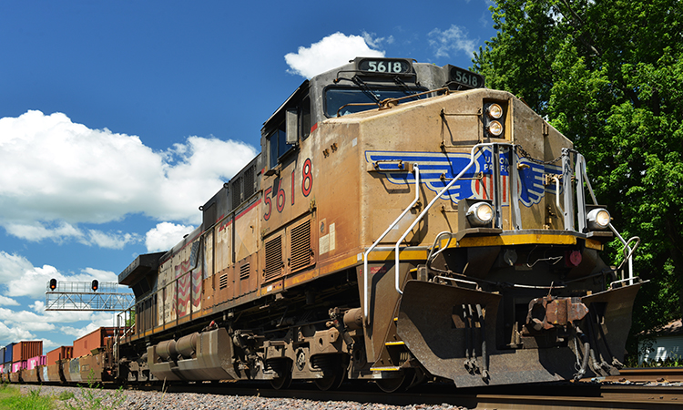 Union Pacific diesel locomotive pulling a freight train of container cars
