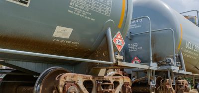Two railroad tank cars displaying flammable hazardous materials signs