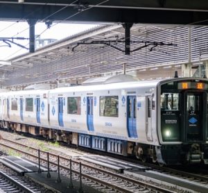 Battery-electric commuter train at a station, capable of running on partially electrified and non-electrified lines, representing modern rail decarbonisation.