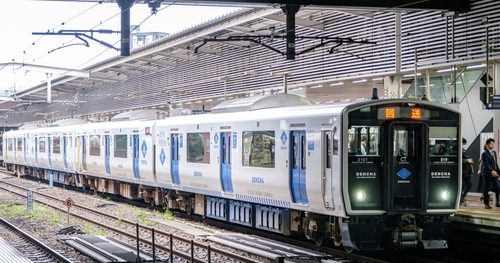 Battery-electric commuter train at a station, capable of running on partially electrified and non-electrified lines, representing modern rail decarbonisation.