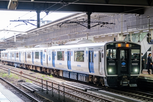 Battery-electric commuter train at a station, capable of running on partially electrified and non-electrified lines, representing modern rail decarbonisation.