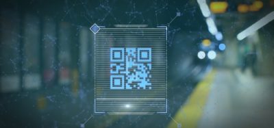 A digital scan of a QR code set against the backdrop of a train station.