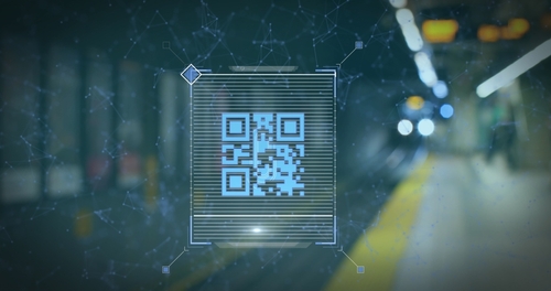 A digital scan of a QR code set against the backdrop of a train station.