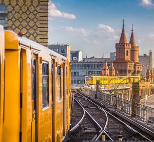 Panoramic view of Berliner U-Bahn with Oberbaum Bridge in the background in golden evening light at sunset with retro vintage Instagram style hipster filter effect, Berlin Friedrichshain-Kreuzberg