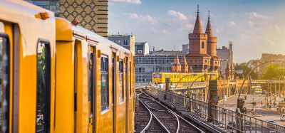 Panoramic view of Berliner U-Bahn with Oberbaum Bridge in the background in golden evening light at sunset with retro vintage Instagram style hipster filter effect, Berlin Friedrichshain-Kreuzberg