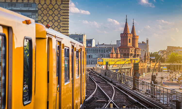 Panoramic view of Berliner U-Bahn with Oberbaum Bridge in the background in golden evening light at sunset with retro vintage Instagram style hipster filter effect, Berlin Friedrichshain-Kreuzberg