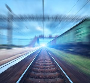 Railway station featuring motion blur and cargo wagons