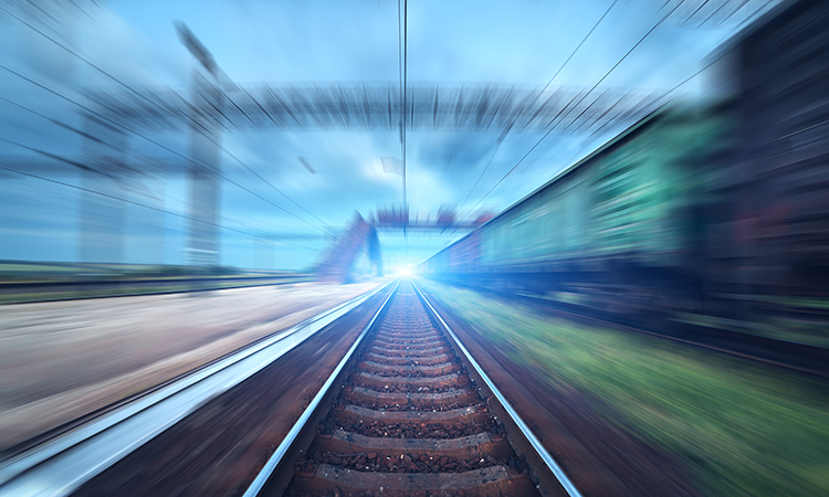 Railway station featuring motion blur and cargo wagons