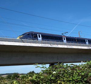 Kent, England, The Javelin high speed train crosses the river Medway travelling towards the coast at high speed.