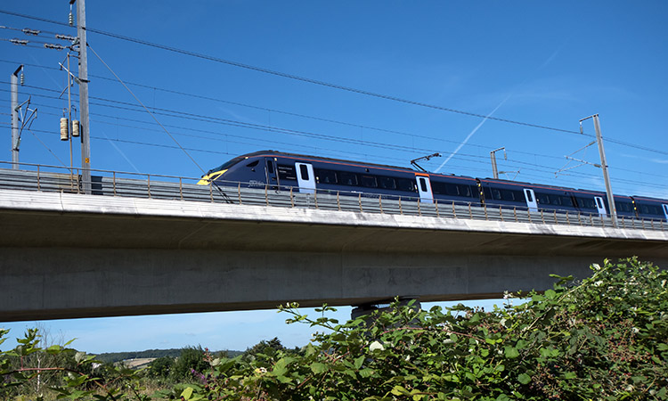 Kent, England, The Javelin high speed train crosses the river Medway travelling towards the coast at high speed.