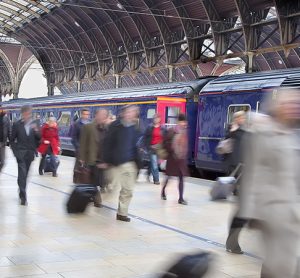 Commuters at Paddington station blurred with slow shutter speed, with all logos removed and all faces blurred beyond recognition.