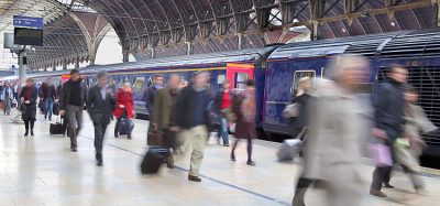 Commuters at Paddington station blurred with slow shutter speed, with all logos removed and all faces blurred beyond recognition.