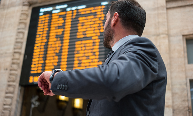 Businessman checking time while watching