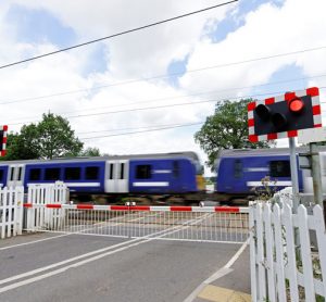 Train speeding through level crossing in the United Kingdom