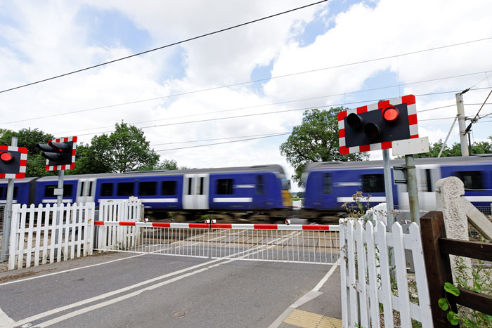 Train speeding through level crossing in the United Kingdom