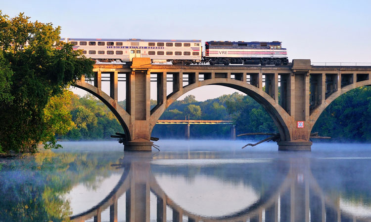 A Virgina Railway Express commuter train passing over the Rappahannock River.